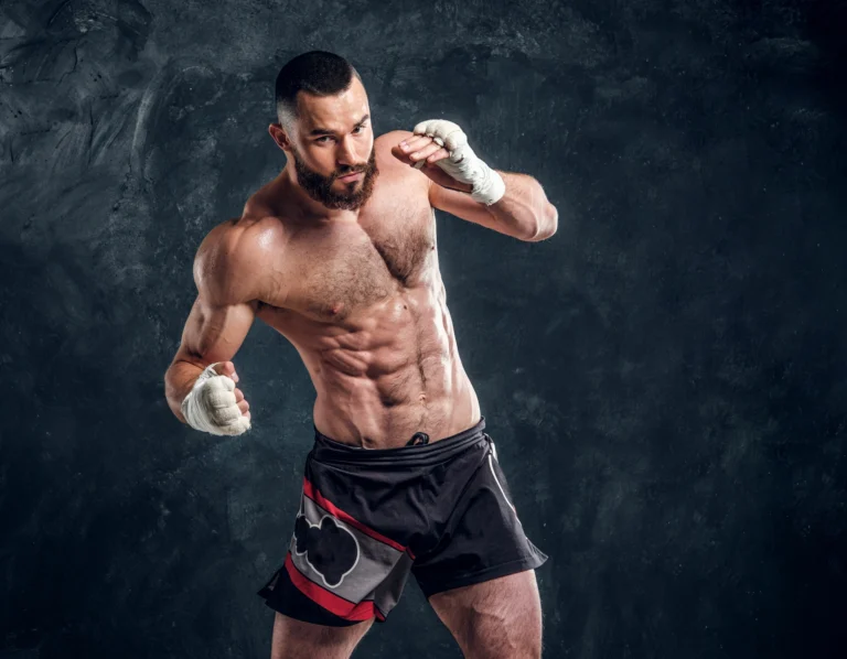 manly bearded man with beautiful muscular torso is posing photographer dark background ()